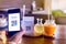 Selective focus to Hand using smart phone to scan QR code on tag with blurry lemongrass juice and Orange juice