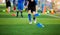 Selective focus to kid soccer player mark blue cone marker