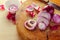 Selective focus to slice purple onion on wood board.