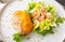 Selective focus and top view shot of well prepared meat fried fillet with luxury decoration of vegetables lettuces, tomatoes