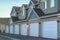 Selective focus of townhomes with white garage doors against mountain and sky