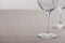 Selective focus of transparent wine glasses isolated on grey