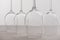 Selective focus of transparent wine glasses on tablecloth isolated on grey