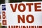 Selective focus on VOTE NO on a political sign.