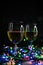 selective focus. Wine glasses in the light of Christmas lights