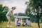 selective focus of woman with golf club playing golf and friends resting at golf cart