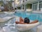 selective focus of woman relaxing in a chair in swimming pool