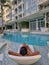 selective focus of woman relaxing in a chair in swimming pool