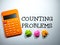 Selective focus.Word COUNTING PROBLEMS with calculator and colorful crumpled paper on white background.Business concept.