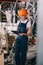 Selective focus of workwoman in overalls