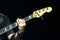 Selective focus on young Asian man bassist`s left hand playing chord on neck of electric bass solo on stage at concert