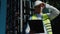 Selective focus of young caucasian civil engineer wearing safety helmet and vest standing at construction site