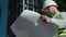 Selective focus of young caucasian civil engineer wearing safety helmet and vest standing at construction site