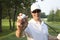 Selective focus of a young male golfer holding golf ball out in