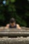 selective focus of a young man performing calisthenics exercises on wooden bars with handstand