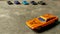 A selective focused car toy. Closeup of orange toy car for children on diverse background