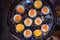 Selective Focused Cooked Quail Eggs in heating mantle indented frying pan. Traditional Thai Street Comfort Food, Asian Cuisine,
