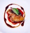 Selective Focused pan seared Foie Gras with berry sauce decoration served on white porcelain plate. Duck or Goose Fattened Liver