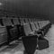 Selective perspective view towards empty audience seat in an indoor performance hall or cinema