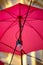 Selective photo shot of a light bulb with blurred pink umbrella background