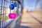 Selective shot of blue and pink heart-shaped love padlocks, locked to fence,concept of eternity love