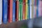 Selective shot of colorful plastic laundry clothespins hanging in a line in a daytime