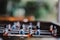 Selective shot of an old foosball football player figures with a blurred view of playroom behind