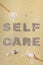 Self care an inscription on a beige neutral background made of natural clay