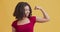 Self-confident black girl showing biceps, feeling power