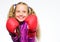 Self defence concept. Girl child strong with boxing gloves posing on white background. She ready to defend herself