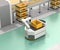 Self driving AGV with robotic arm moving beside conveyor