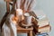 Self isolation, please stay home. Still life details in home interior of living room. Sweaters and cup of warming beverage, books