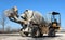 Self loading mini concrete mixer truck half covered with cement dust