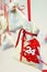 Self made Advent calendar linen bag with red Christmas tree ornament with 24 december date tied with silk ribbon hanging on string