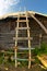 Self made old wooden ladder near the rural house wall