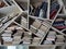 A self-made wooden bookshelf of unusual shape completely filled with new and old books of different thickness and sizes.