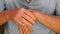 Self Massage Left Wrist of an Adult Male Wearing a Blue Shirt Closeup