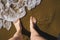 Self photo of the feet on the sand of a beach, waves coming towards the feet