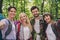 Self-portrait of attractive four cheerful people hikers exploring country world on fresh air vacation outdoors