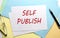 SELF PUBLISH text on paper on the colorful paper background