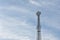 Self support type telecommunication tower against blue sky background.