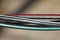 self-supporting insulated antivandal black wire with red white and green stripes.
