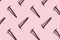 Self-tapping screws on a pink background, pattern, hard shadows. Construction tools, repairs. Background for the design