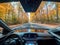 Selfdriving car cruising through forest with AI windshield