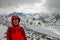 Selfi male mountaineer in snowy mountains, wearing a helmet with a backpack