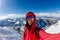 Selfi male mountaineer in snowy mountains, wearing a helmet with a backpack