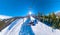 SELFIE: Active tourists on snowboarding trip ride ski lift on perfect winter day