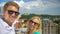 SELFIE: Cheerful couple films a new vlog post from a rooftop in sunny Slovenia.