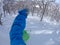 SELFIE: Cool snowboarder carves the fresh powder snow and evades the trees.