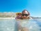 Selfie of cute couple laying in shallow sea water on the Balos b